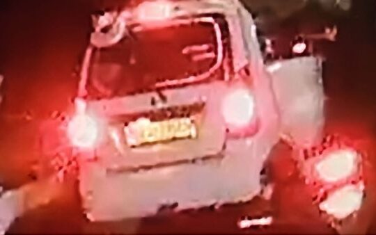 Lost white Wagon R vehicle with back mirror on top and writing on the back glass, last seen traveling from Swastic to Manipal Hospital.