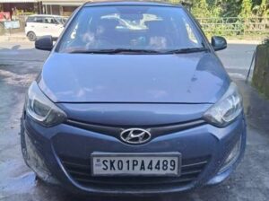 An i20 Sports, old model, manufactured in 2013, with all documents proper, 70k km running, well-maintained, and single-used, is for sale in Sikkim.